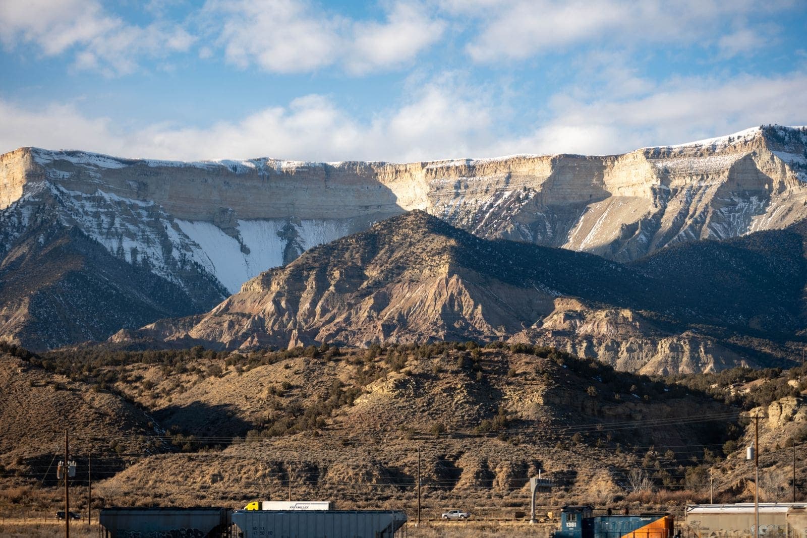 Layered cliffs and mountains under a clear sky
