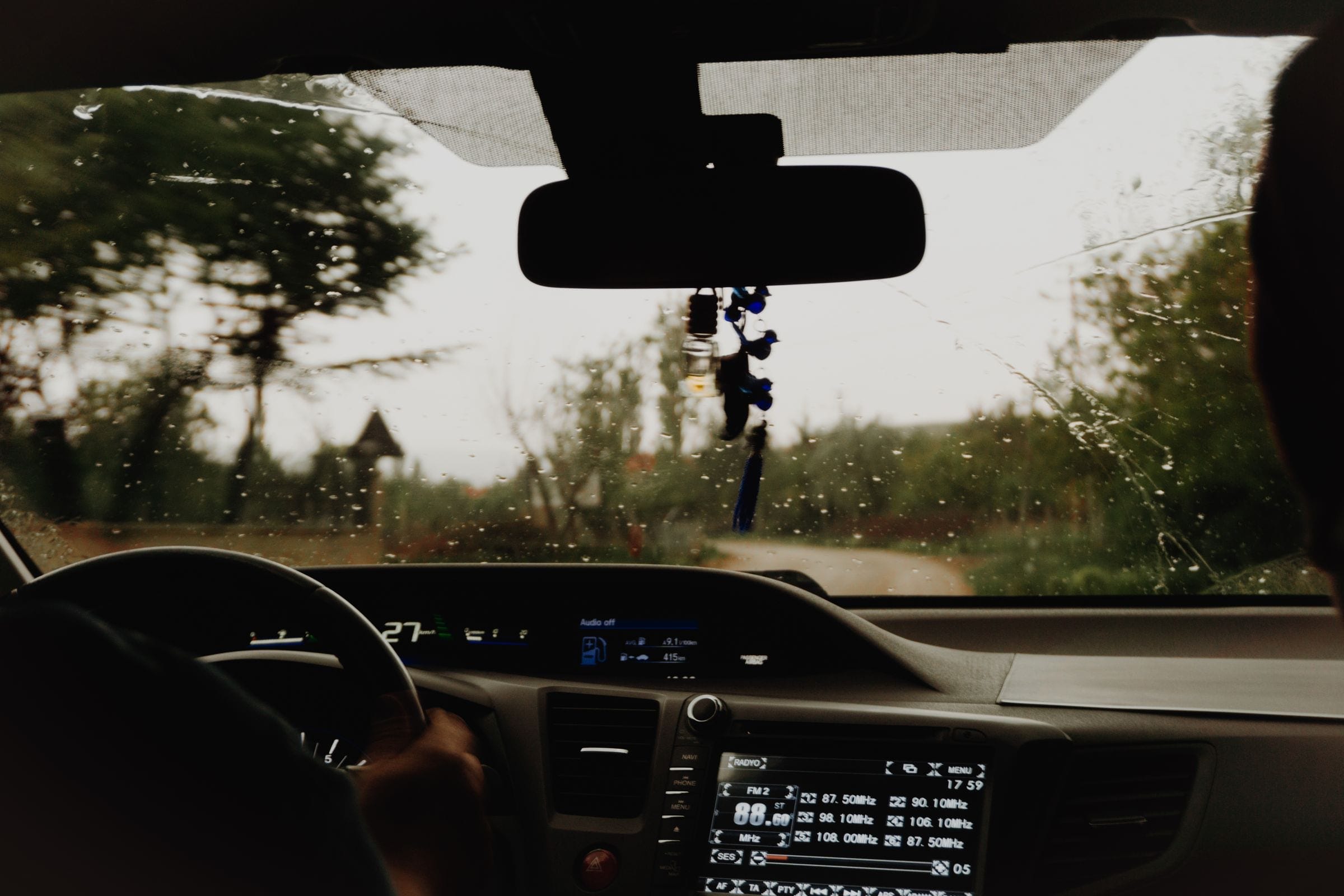 Driver view through a windshield with the camera mount and dashboard screen, the setup ADAS calibration aims